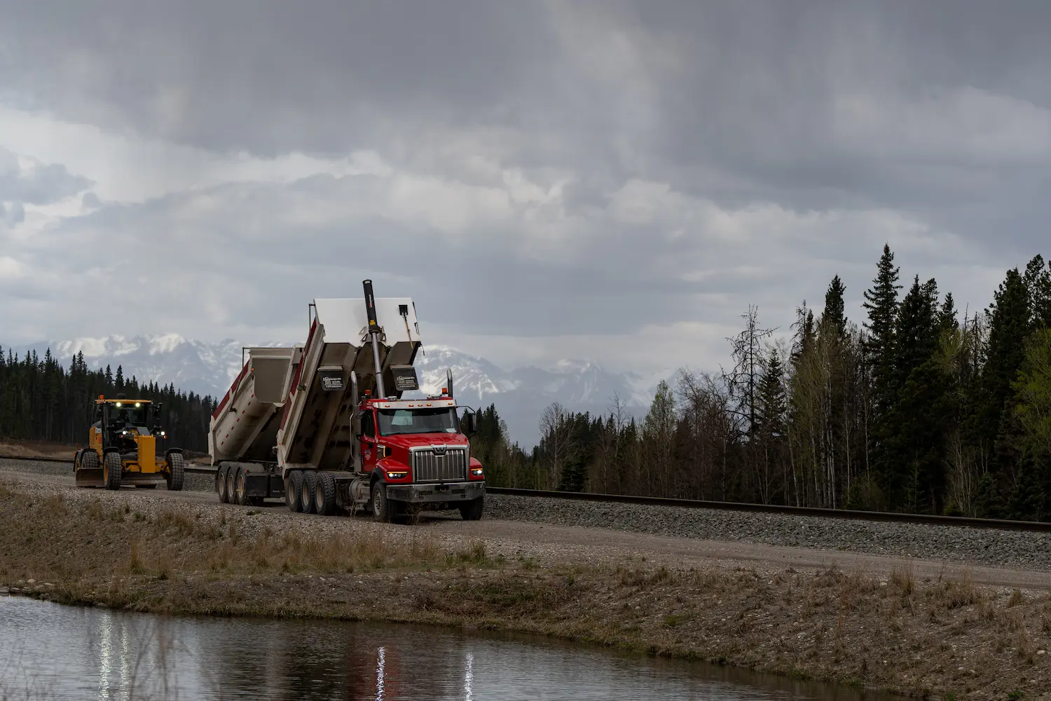 west central truck and grader with scenic mountain background