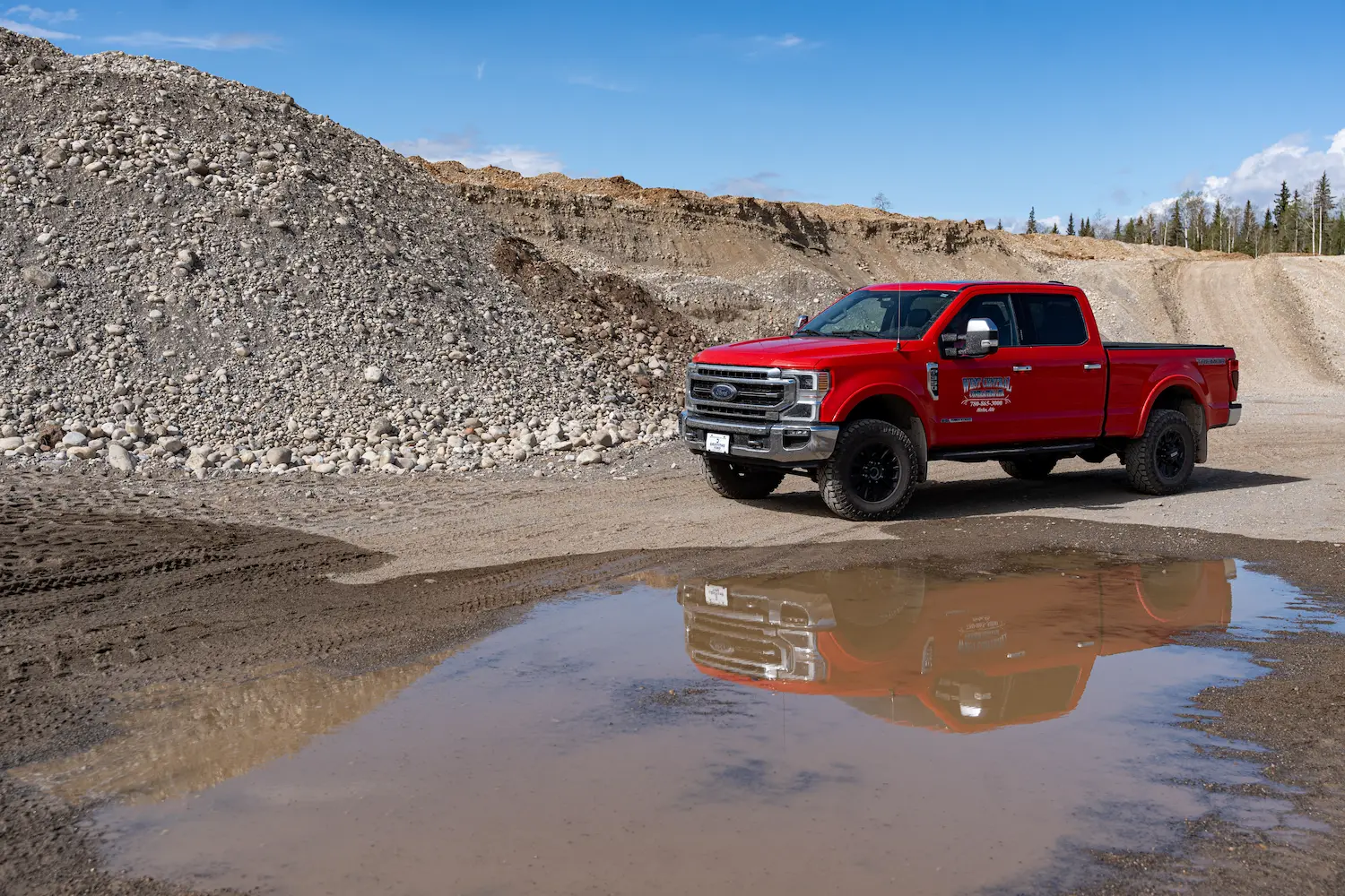 West central contracting pickup truck in a rock pit